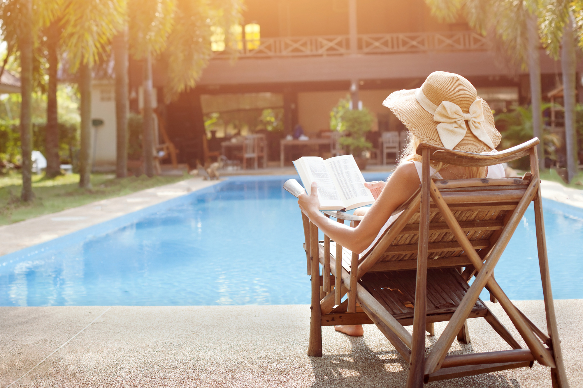 Reading Book By Hotel Pool