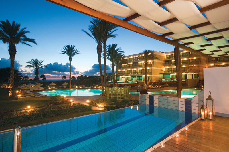 Pool view at night at Constantinou Bros Asimina Suites Hotel