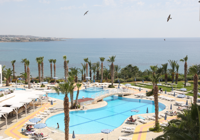 View of beach from pool at Ascos Coral Beach Hotel